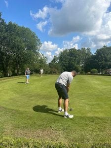 Attendees enjoying a game of golf