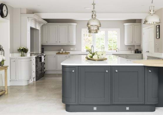 Laura Ashley Harwood kitchen with two tone cabinets in white and grey featuring curved cabinets and island.