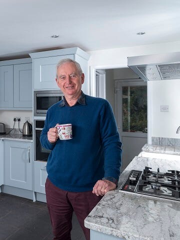 Blue painted kitchen with stone worktops 