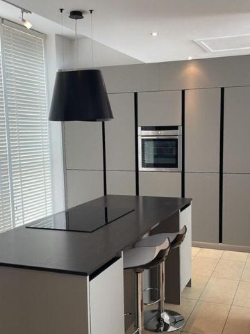 modern dark grey Rotpunkt kitchen with island and induction hob